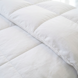Close-up of the Yafet Winter Duvet box-stitch squares and piped edge